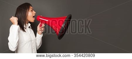 Black Woman Student Skreaming With Loudspeaker On Gray Background