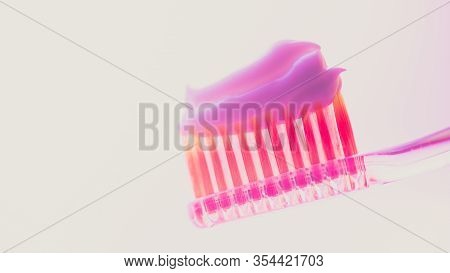 Pink Plastic Toothbrush With A Thick Layer Of White Toothpaste On An Isolated Background.