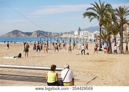 Benidorm, Spain - February 25, 2020: Active Senior People Doing Sport Exercises On The Beach. Health
