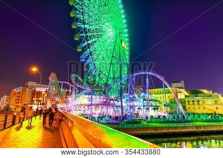 Yokohama, Japan - April 21, 2017: Asian People Cross The Bridge Joining Cosmo World Amusement Park I