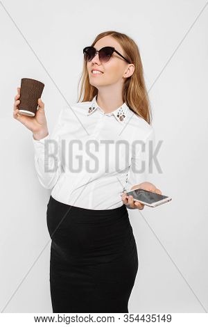 Image Of A Young Pregnant Businesswoman Wearing Glasses, A Girl Holding A Smartphone And Drinking Co