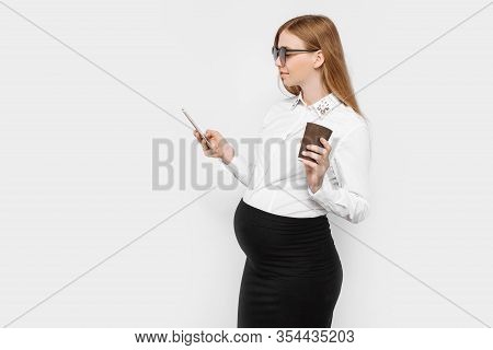 Image Of A Young Pregnant Businesswoman Wearing Glasses, A Girl Holding A Smartphone And Drinking Co