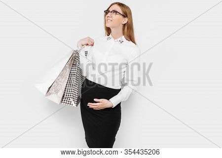 The Image Of A Young Pregnant Businesswoman With Glasses, Happy Girl Holding Shopping Bags, Shopping
