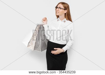 The Image Of A Young Pregnant Businesswoman With Glasses, Happy Girl Holding Shopping Bags, Shopping