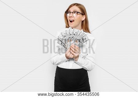 Image Of A Young Pregnant Businesswoman In Glasses Posing, Holding Banknotes In Her Hands, Planning