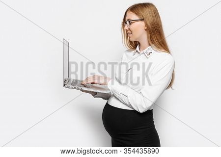 Image Of A Young Pregnant Businesswoman In Glasses Posing With A Laptop