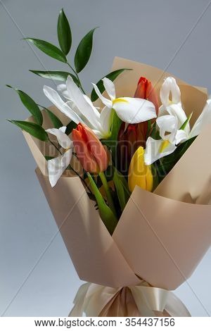 Close-up Fresh Spring Bouquet Of Tulip, Iris, Ruscus On A Gray Background, Selective Focus