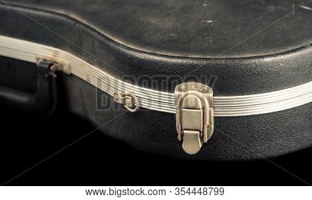 A Worn Violin Case Shot Against A Black Background
