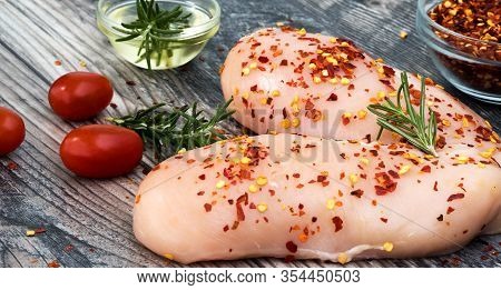 Raw Chicken Breast With Rosemary, Vegetables  And Red Pepper On Wooden  Board. Chicken Breast