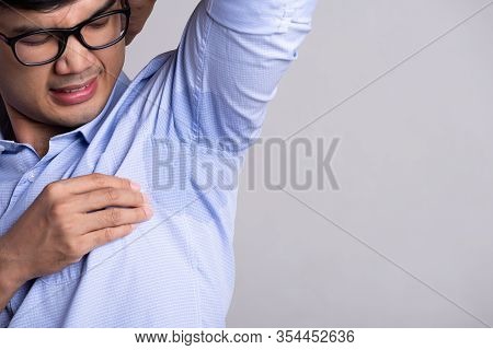 Close Up Asian Man With Hyperhidrosis Sweating. Young Asia Man With Sweat Stain On His Clothes Again