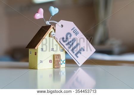Home For Sale And Real Estate Mortgage Concept: Diy Little House Model With Tag Paper 