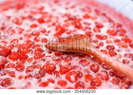 Strawberry Jam Cooking Process. Wooden Spoon Liying On Jam Surface. Organic Traditional Jam Manufact