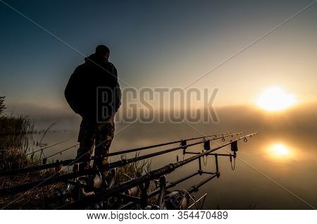 Fishing Adventures, Carp Fishing. Angler, At Sunset, Is Fishing With Carp Fishing Technique.