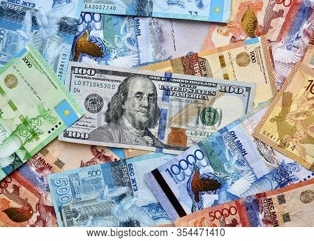 Us Dollar Banknote On Top Of Kazakhstan National Currency, Top View Of Mixed Tenge Banknotes. Kz Pap