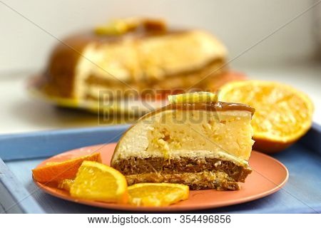 Cut Orange Caramel Mousse Cake With Cream Cheese Mascapone And Chocolate Glaze With Orange Pieces Cl