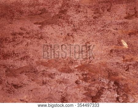 Peeling Red Paint With Rust. The Rough Texture Of The Metal Wall. The Old Surface Is Burgundy. Grung