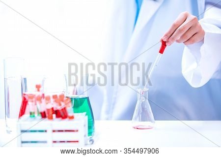 Asian Scientist Working In Science And Chemical For Health. Doctor With Virus In Lap Test To Protect