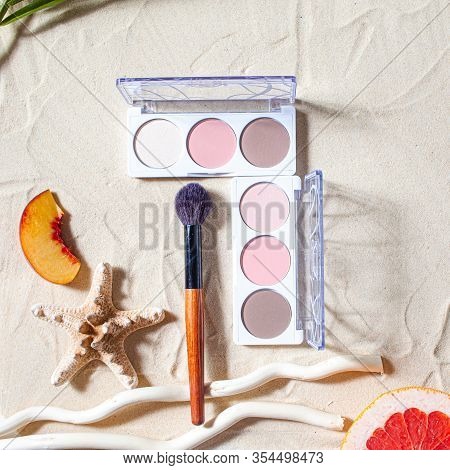 Vacation. A Sculpting Palette And A Blush Brush Lie On The Beach Sand, Surrounded By Vibrant Fruits,