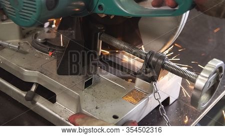 Grinding In Steel Manufactory. Working Man With Big Saw Cutting Metal. Dangerous And Hard Work Conce