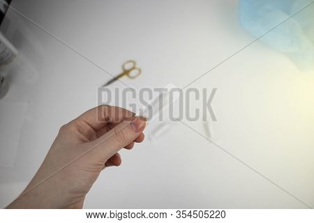 Vaginal Or Rectal Candle In Hands On A Light Background. The Drug Is In The Form Of Suppositories. T