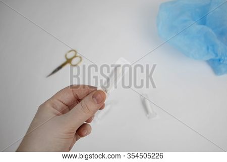 Vaginal Or Rectal Candle In Hands On A Light Background. The Drug Is In The Form Of Suppositories. T