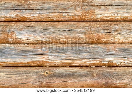 A Wall Of Four Horizontal Wooden Logs. Pine Trunks Are Dry, There Are Cracks And Crevices. Close-up 