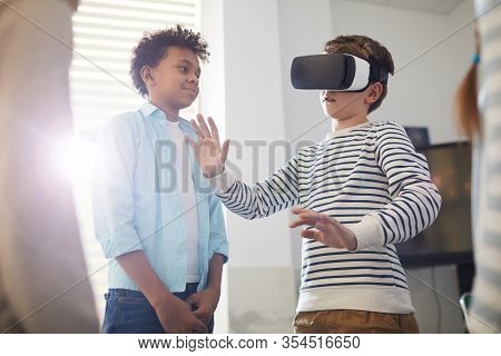 Ten-year-old Boy Wearing Vr Headset For The First Time And His Friends Looking At Him, Horizontal Sh