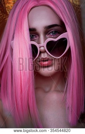 Portrait Of Teenage Model With Pink Hair. Funky Teenager Wearing Color Wig And Trendy Glasses. Verti