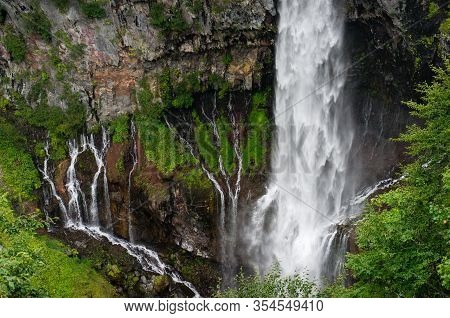 Close Up Of Massive Waterfall Stream With Cliff Rocks. Waterfall Nature Background