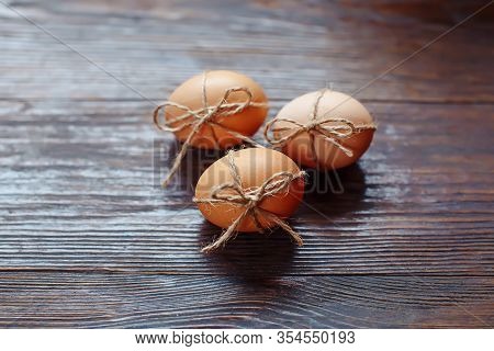 Easter Beige Eggs Decorate With Rope On Brown Wooden Background