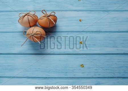 Easter Beige Eggs Decorate With Rope On Blue Wooden Background