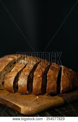 Sliced Fresh Bread With Golden Crust On A Wooden Board. Flour And Yeast.