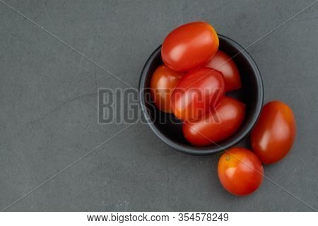 Cherry Tomatoes In Mini Black Bowl To Prepare For Cooking. Concept Of Ingredient In Thai Food