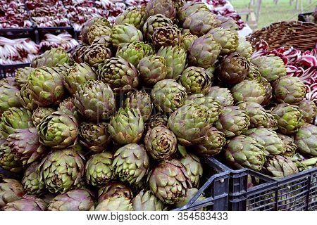 Pile Of Big Greens Artichokes In The Boxes For Sale Of The Greengrocer S Stall At The Local Market