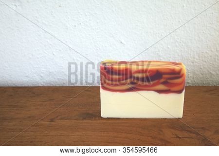 Handmade Slice Of Soap On Wooden Surface