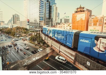 Bangkok, Thailand: Cityscape With Cars And Subway Train Driving Under Scyskrapers On February 21, 20