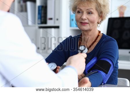Close-up Of Smiling Elderly Woman On Appointment With Experienced Therapist. Professional Practition