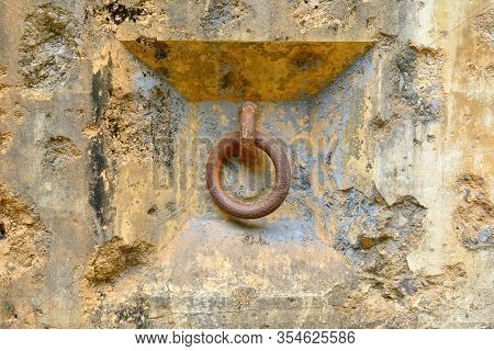 Rusted Metal Ring Hanging In Old Wall In Corregidor Island, Cavite, Philippines.