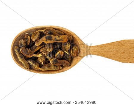 Fruit Of Styphnolobium Japonicum In A Wooden Spoon On A White Background