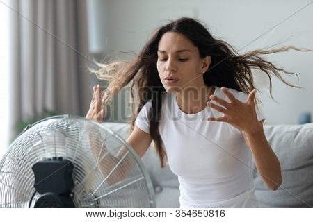 Millennial Girl Suffer From Hot Weather Use Floor Fan