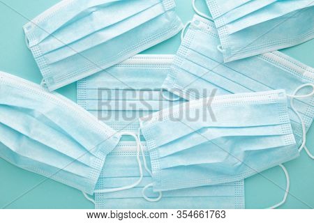 Meny Medical Masks On Mint Background. Coronavirus, Top View