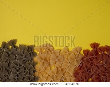 Traditional Italian Farfalle Pasta In National Flag Tricolor Style On Yellow Background With Copy Sp