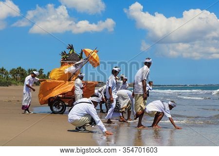 Bali Island, Indonesia - March 18, 2015: Balinese People Procession Walking By Beach With Hindu Scar