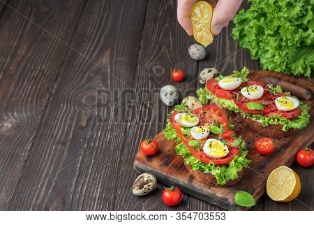 Two Avocado Sandwich On Ciabatta Bread Made With Fresh Sliced Avocados, Quail Eggs And Vegetables. L