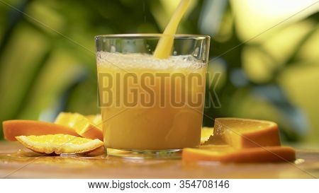 Fresh Orange Juice Pouring Into A Glass