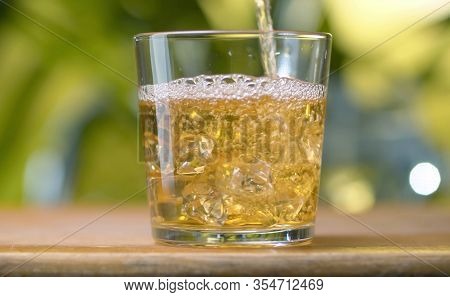 Glass Of Apple Juice Pouring