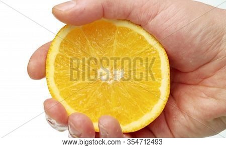 Male Hand Squeezing An Orange