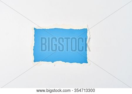 Ripped Blue Paper Torn Edge Sheet On A White Background. Template With Piece Of Color Paper