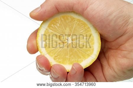 Male Hand Squeezing A Lemon