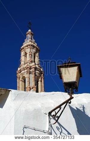 View Of St Giles Church Bell Tower (iglesia De San Gil) And Ornate Streetlight, Ecija, Seville Provi